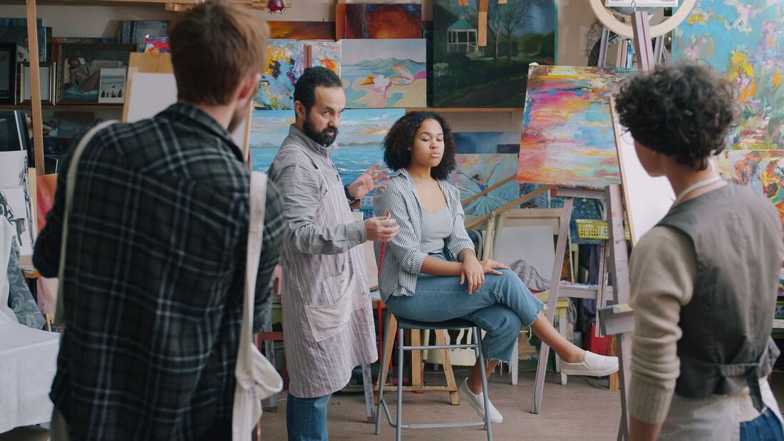 Students and instructor in a busy painting studio